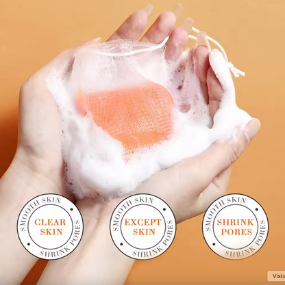 Hand holding a bar of soap with lather, against a beige background